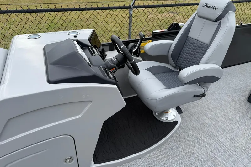 Slide: The Image of Captain's chair and helm of 2026 Bentley Pontoons Elite 253 Swingback, featuring sleek design and controls. - 5