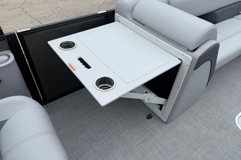 Slide: The Image of 2026 Bentley Pontoons Elite 253 Swingback interior with foldable table and cup holders. - 9