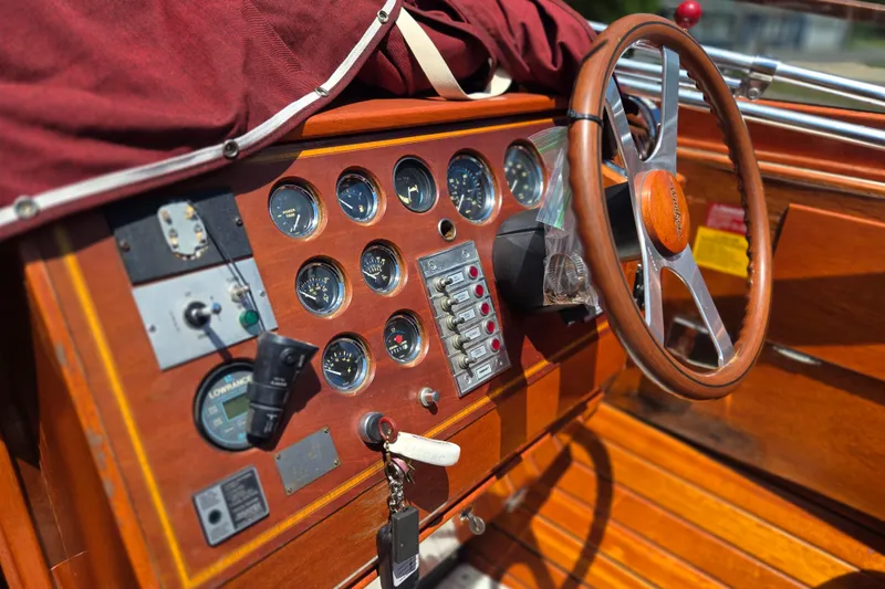 Slide: The Image of 1990 Windsor Craft Cuddy boat dashboard with wooden steering wheel and instrument panel. - 10