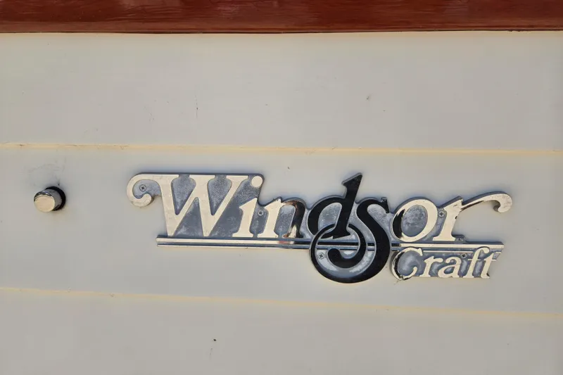 Slide: The Image of Windsor Craft Cuddy 1990 logo on boat exterior. - 11