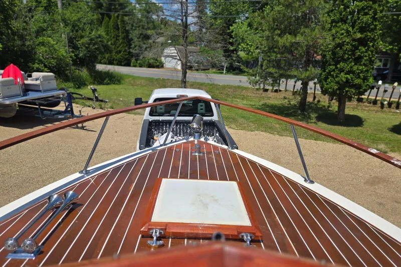 Slide: The Image of 1990 Windsor Craft Cuddy boat with wooden deck, parked outdoors on a sunny day. - 13