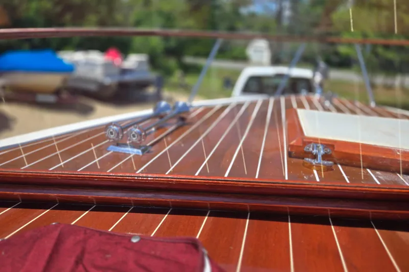 Slide: The Image of 1990 Windsor Craft Cuddy boat with polished wooden deck and chrome fittings. - 15