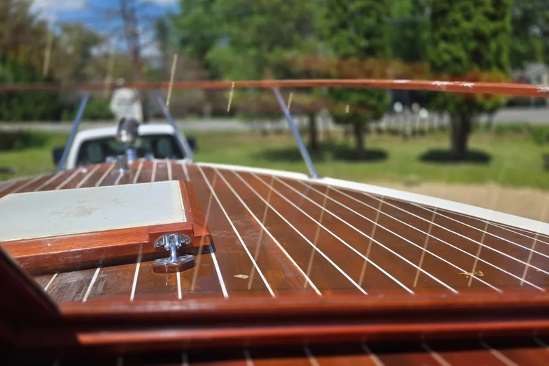 Slide: The Image of 1990 Windsor Craft Cuddy boat with polished wooden deck, outdoors. - 16
