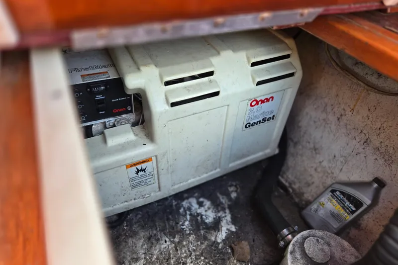 Slide: The Image of Onan marine generator in a 1990 Windsor Craft Cuddy boat engine compartment. - 19