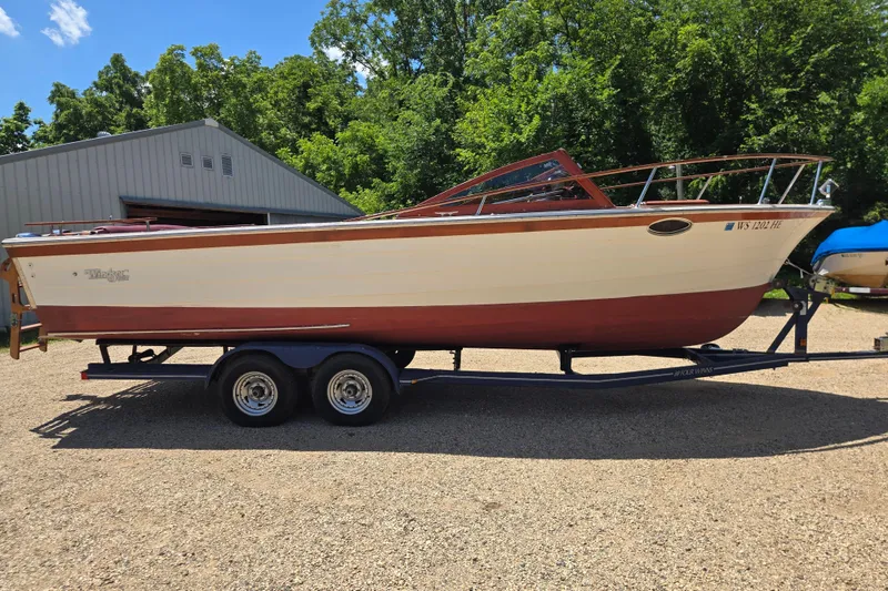 Slide: The Image of 1990 Windsor Craft Cuddy boat on trailer, parked outdoors near a metal building. - 2