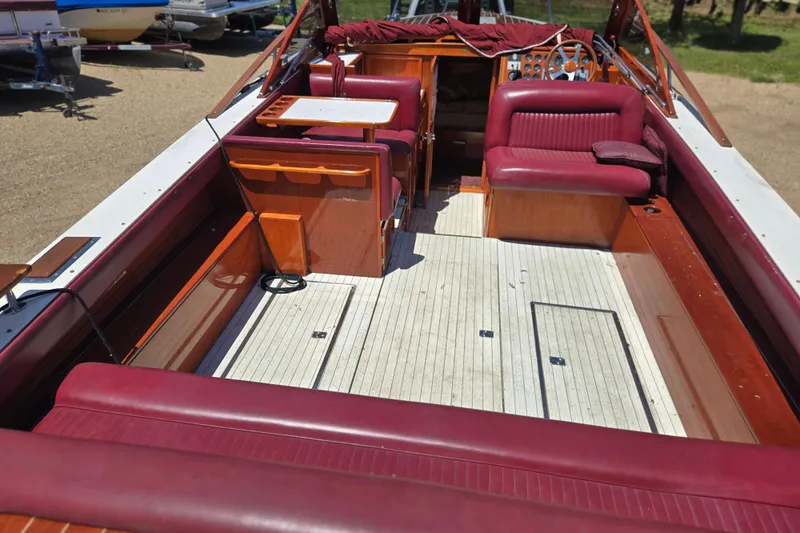 Slide: The Image of 1990 Windsor Craft Cuddy boat interior with red seating and wooden accents. - 24
