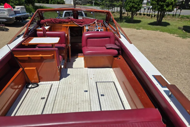 Slide: The Image of 1990 Windsor Craft Cuddy boat interior with red seating and wooden accents. - 25