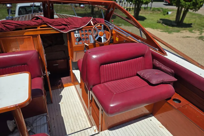 Slide: The Image of 1990 Windsor Craft Cuddy boat interior with red leather seats and wooden dashboard. - 28