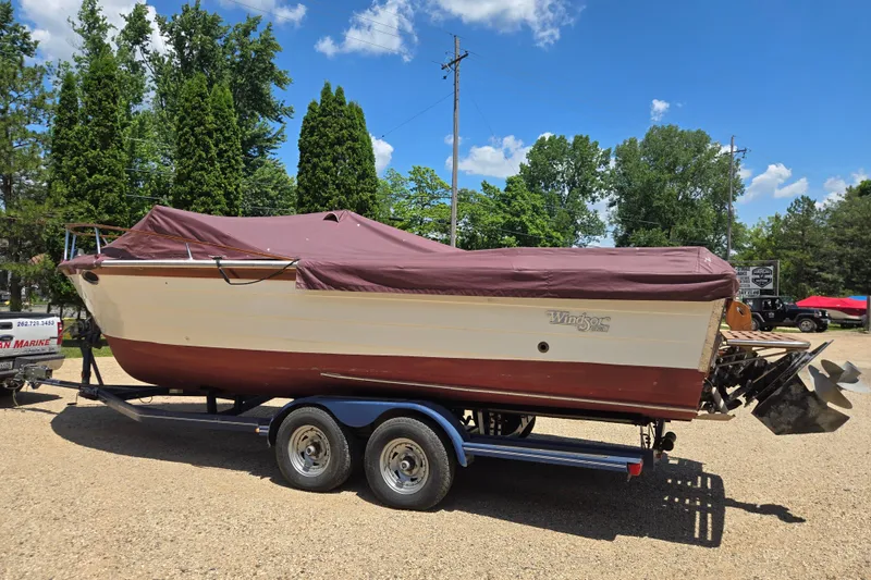 Slide: The Image of 1990 Windsor Craft Cuddy boat on trailer, covered, parked outdoors under blue sky. - 3