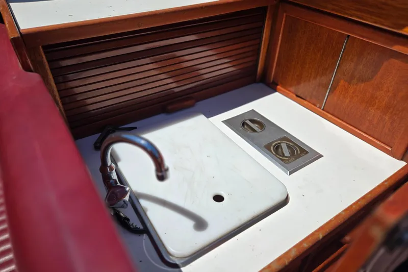 Slide: The Image of 1990 Windsor Craft Cuddy boat interior with sink and wooden cabinetry. - 4