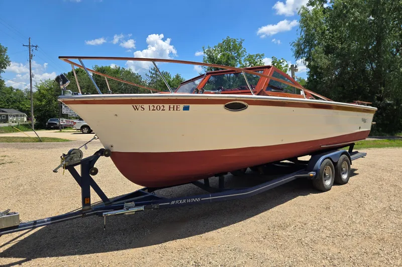 Slide: The Image of 1990 Windsor Craft Cuddy boat on trailer, parked outdoors under a clear blue sky. - 5