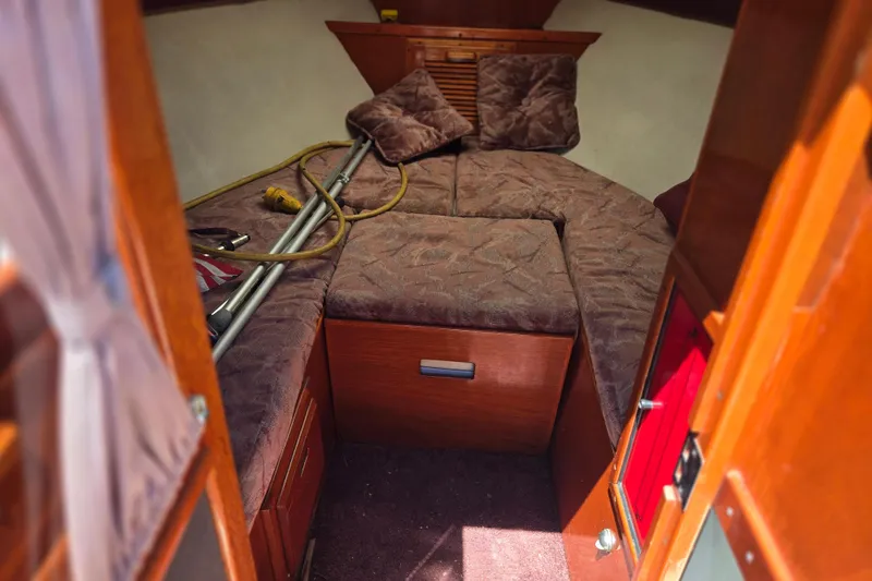 Slide: The Image of Interior of 1990 Windsor Craft Cuddy boat with cozy cabin and cushions. - 8