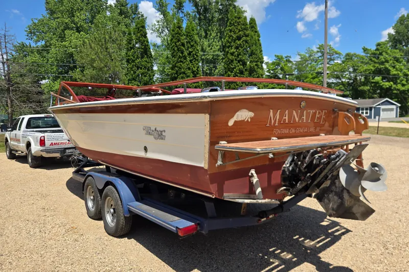 Slide: The Image of 1990 Windsor Craft Cuddy boat on trailer, labeled "Manatee," parked outdoors. - 9