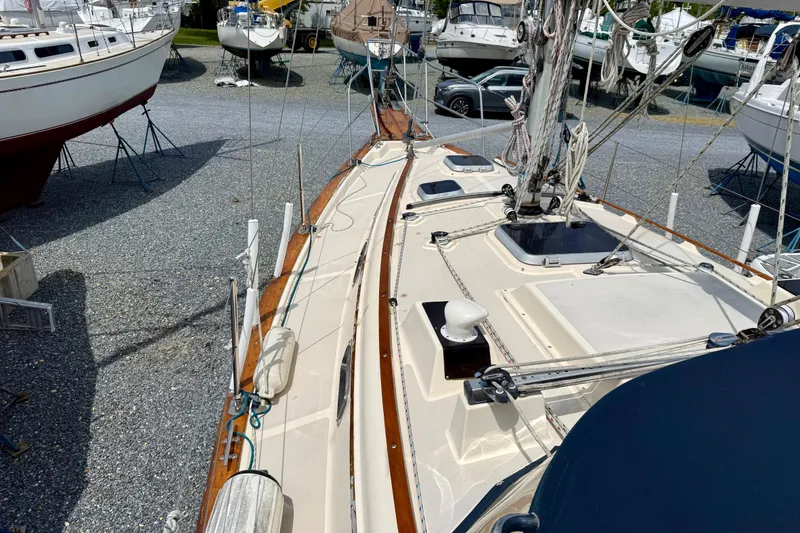 Slide: The Image of 1992 Island Packet 29 sailboat on dry dock, showcasing deck and rigging details. - 3
