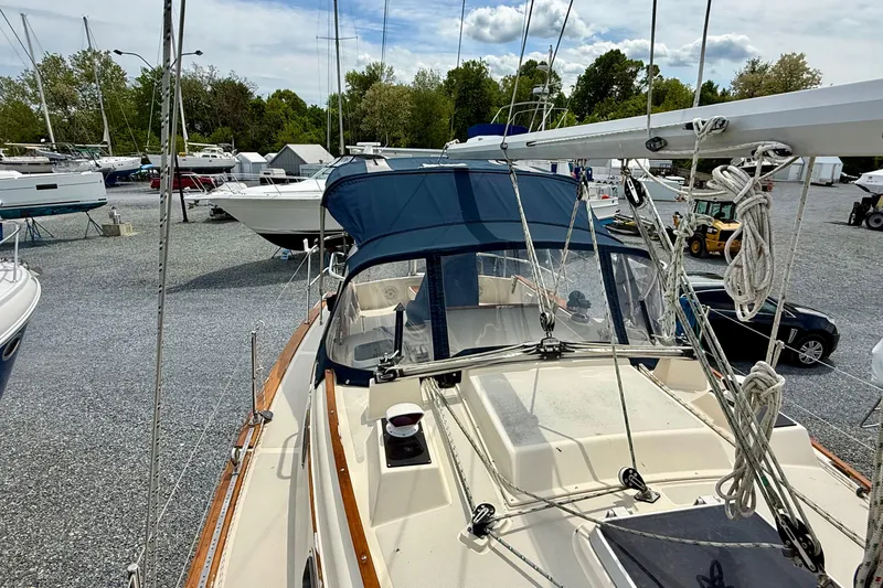Slide: The Image of 1992 Island Packet 29 sailboat docked in a marina, surrounded by other boats. - 6