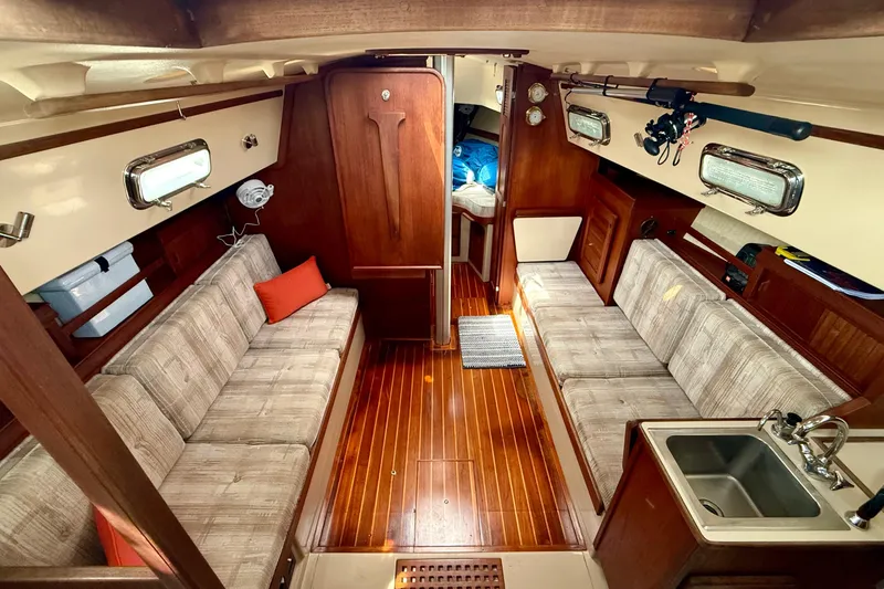 Slide: The Image of Interior of 1992 Island Packet 29 sailboat with wood finish and cozy seating. - 9