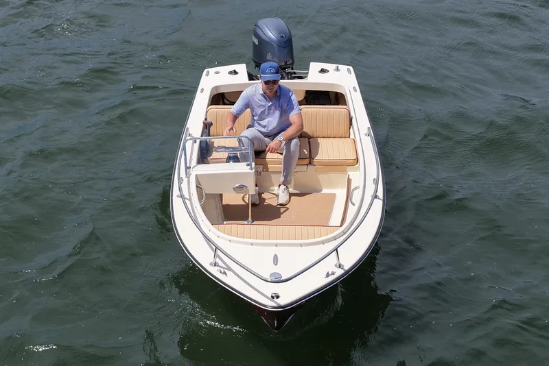 Slide: The Image of 2027 Rossiter 14 boat on water with person seated, showcasing elegant design and comfort. - 11