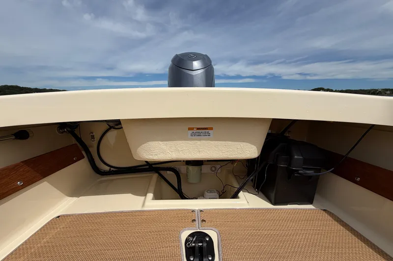 Slide: The Image of Interior view of a 2027 Rossiter 14 boat, showcasing the engine compartment and deck. - 14