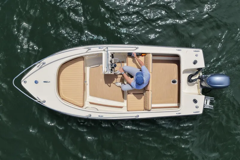 Slide: The Image of Overhead view of 2027 Rossiter 14 boat on water, featuring sleek design and modern outboard motor. - 12