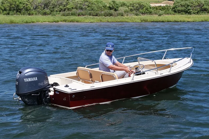 Slide: The Image of 2027 Rossiter 14 boat with Yamaha engine on a scenic waterway. - 1
