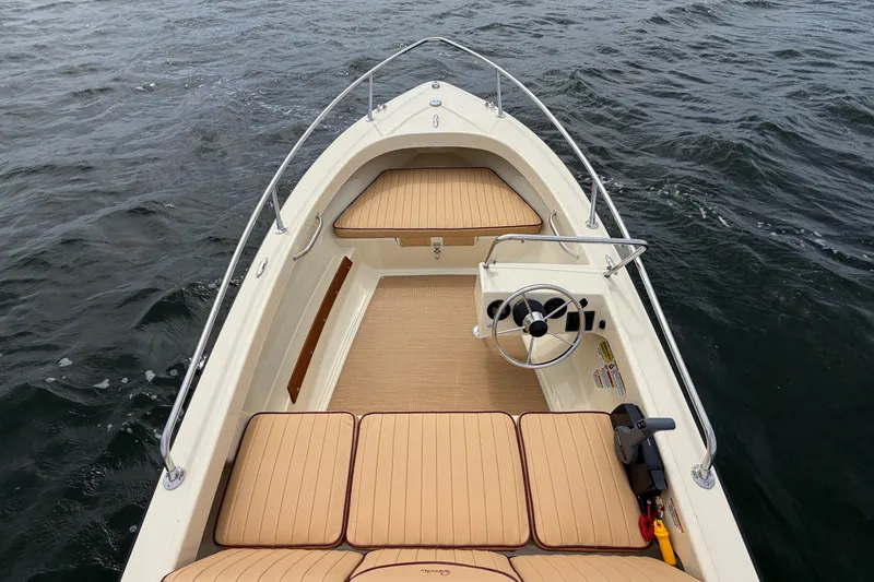 Slide: The Image of 2027 Rossiter 14 boat interior with tan seating on open water. - 25