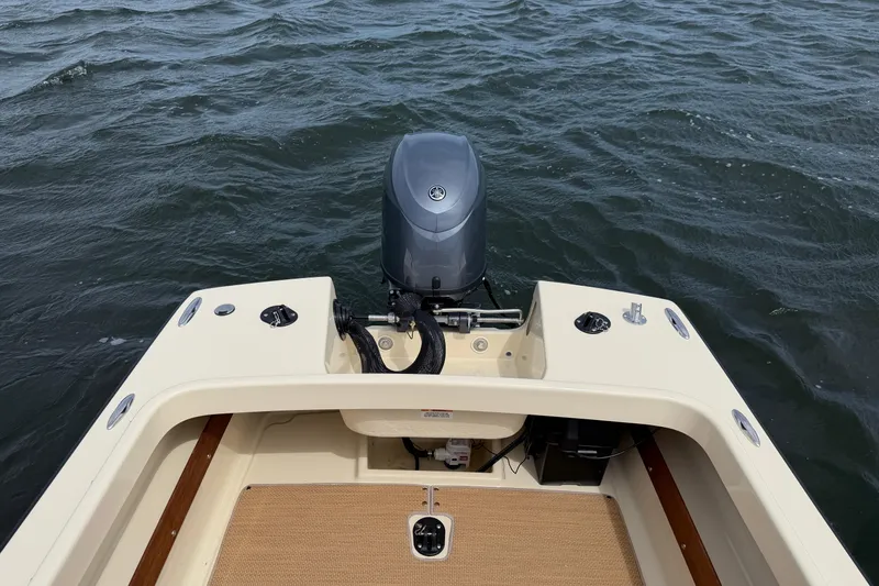 Slide: The Image of 2027 Rossiter 14 boat with outboard motor on open water. - 15