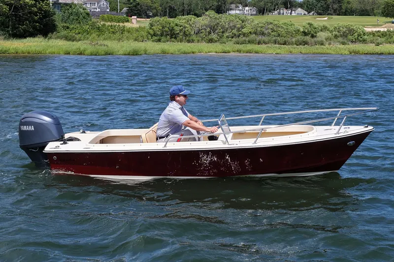 The Image of Man piloting a 2027 Rossiter 14 boat with Yamaha engine on a scenic lake. - 0