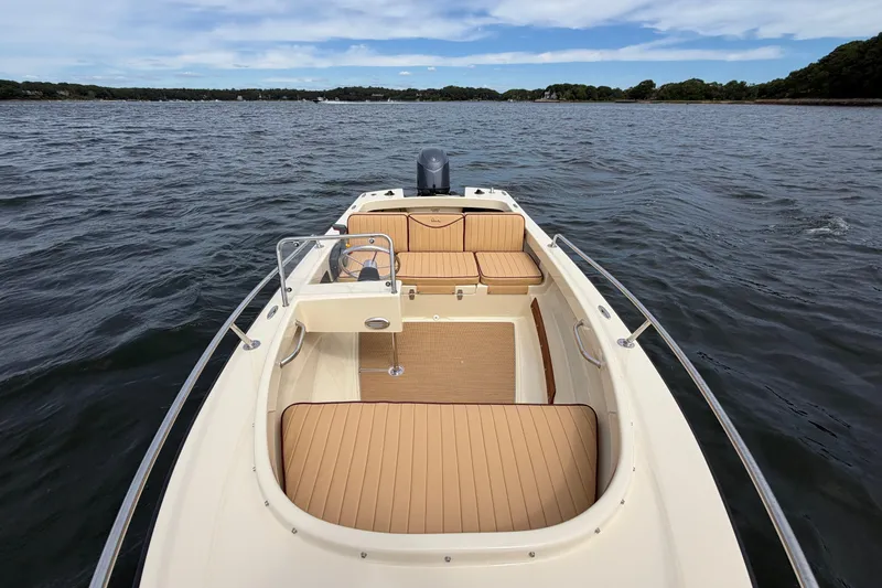 Slide: The Image of 2027 Rossiter 14 boat on water, featuring tan seating and sleek design. - 33