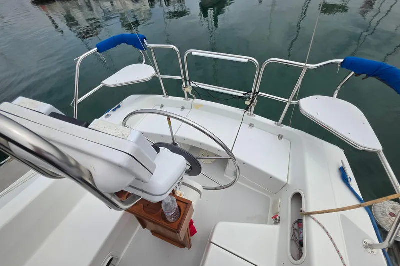 Slide: The Image of Cockpit of a 1999 Catalina 270 sailboat with steering wheel and seating. - 10