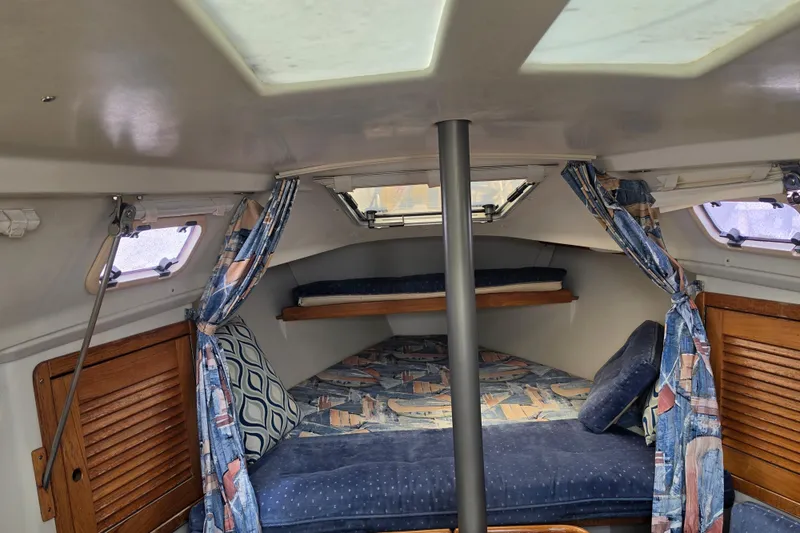 Slide: The Image of Interior of a 1999 Catalina 270 sailboat with cozy cabin and nautical decor. - 13