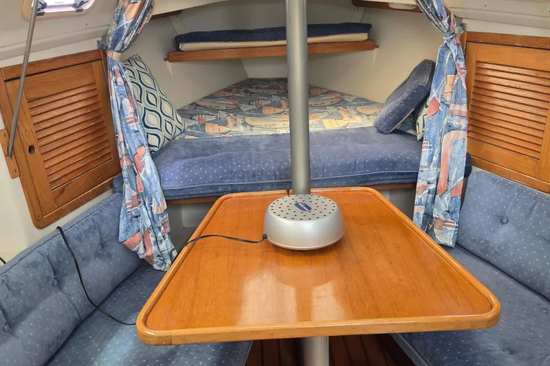 Slide: The Image of Interior of a 1999 Catalina 270 sailboat with cozy seating and wooden table. - 14