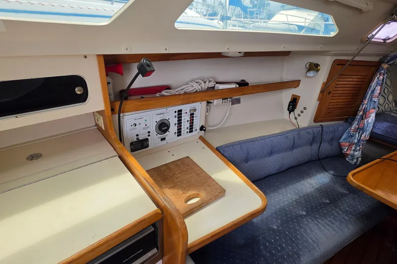 Slide: The Image of Interior of a 1999 Catalina 270 sailboat with navigation station and seating area. - 15
