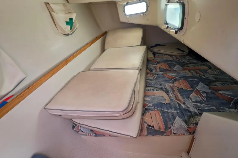 Slide: The Image of Interior cabin of a 1999 Catalina 270 sailboat with cushioned seating and patterned upholstery. - 19