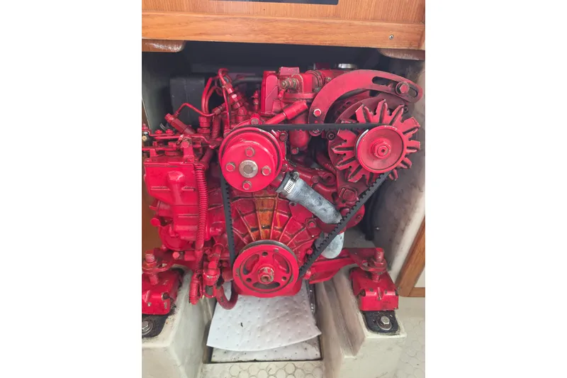 Slide: The Image of Red engine of a 1999 Catalina 270 sailboat, showcasing mechanical components. - 23