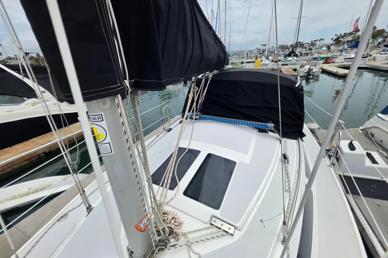 Slide: The Image of 1999 Catalina 270 sailboat docked at marina, featuring sleek deck and rigging. - 4