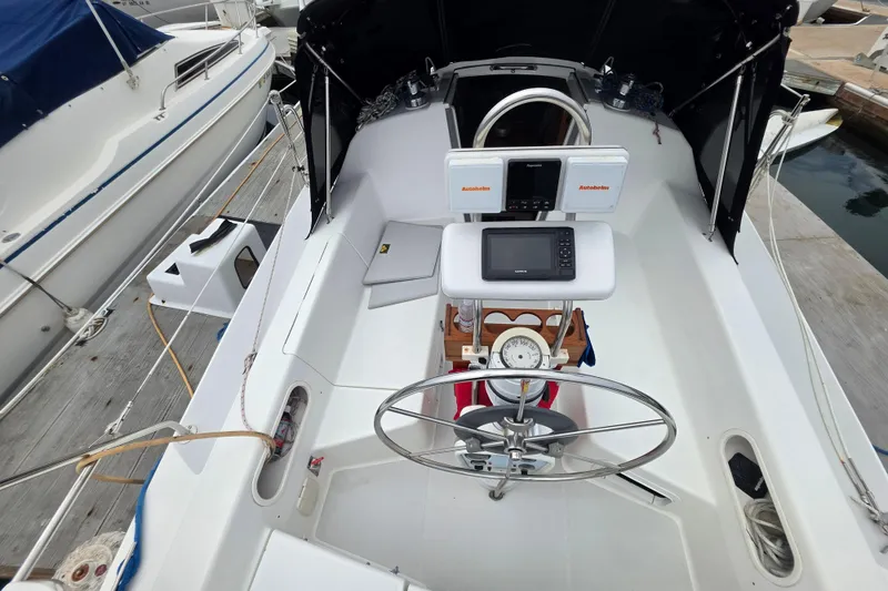 Slide: The Image of Cockpit of a 1999 Catalina 270 sailboat with navigation equipment and steering wheel. - 9