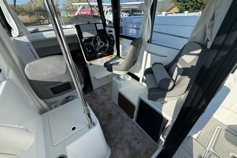 Slide: The Image of Interior of 2026 Jeanneau NC Sport 795 Series 2 boat with modern seating and controls. - 11