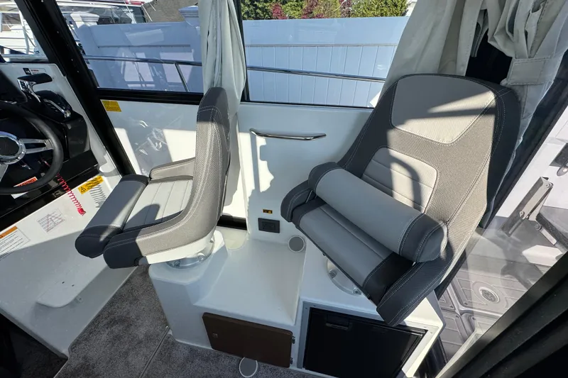 Slide: The Image of Interior of 2026 Jeanneau NC Sport 795 Series 2, featuring two modern boat seats. - 12