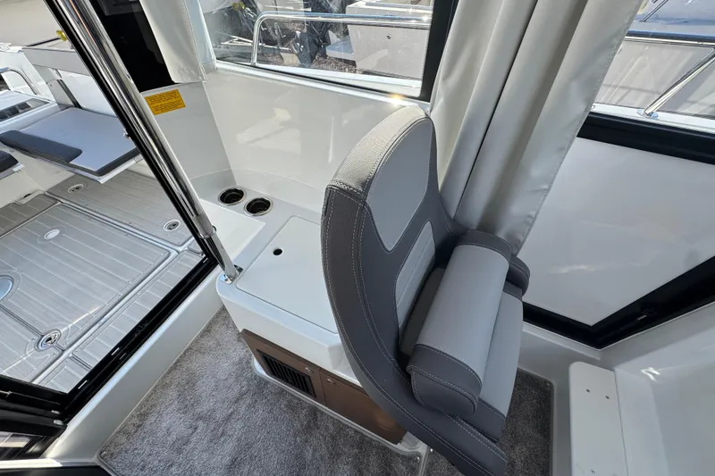 Slide: The Image of Interior of 2026 Jeanneau NC Sport 795 Series 2 boat, featuring seating and cup holders. - 13