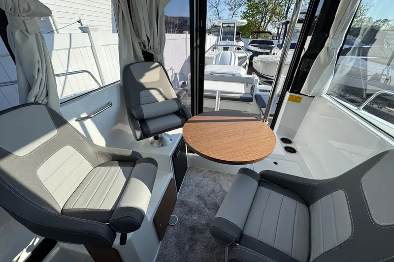 Slide: The Image of Interior of 2026 Jeanneau NC Sport 795 Series 2 boat with seating and table. - 15