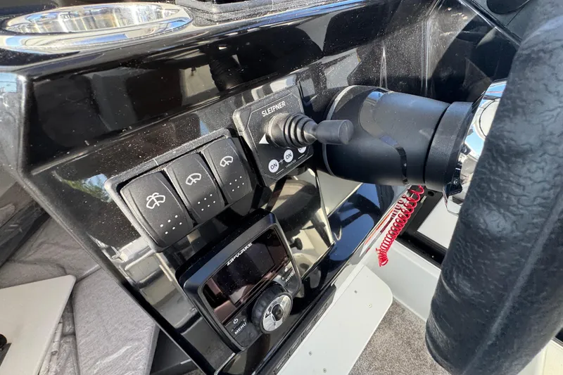 Slide: The Image of Control panel of 2026 Jeanneau NC Sport 795 Series 2 boat with switches and joystick. - 20