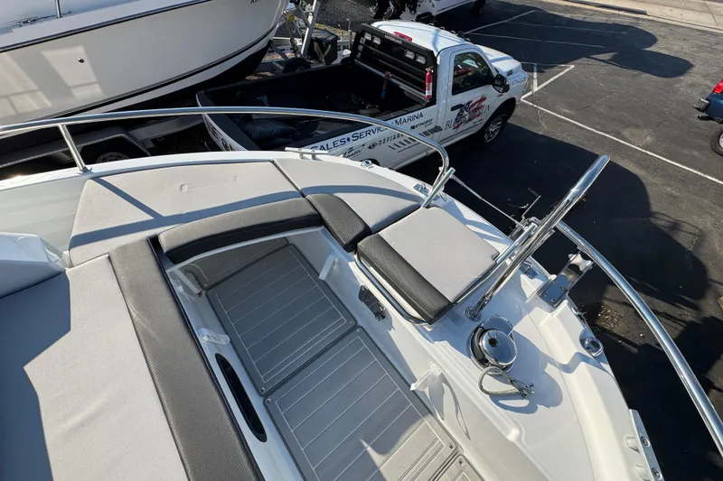 Slide: The Image of 2026 Jeanneau NC Sport 795 Series 2 boat deck with seating and railing, parked near service truck. - 32