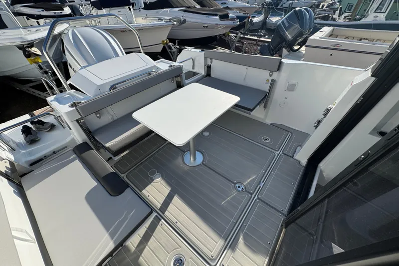 Slide: The Image of 2026 Jeanneau NC Sport 795 Series 2 boat interior with seating and table. - 8