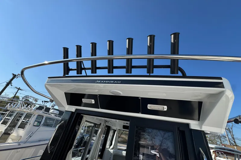 Slide: The Image of 2026 Jeanneau NC Sport 795 Series 2 boat with rod holders against clear blue sky. - 9