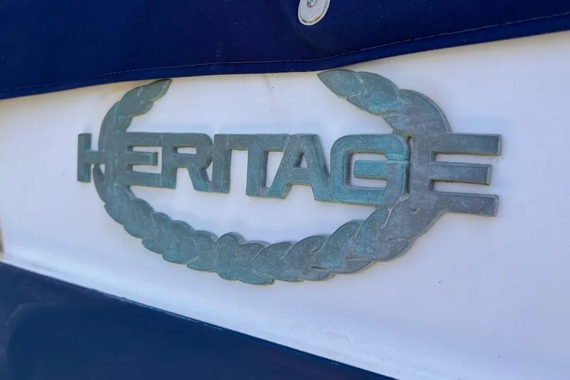 Slide: The Image of Heritage East 40 Sundeck emblem on 1985 trawler, featuring a nautical rope design. - 15