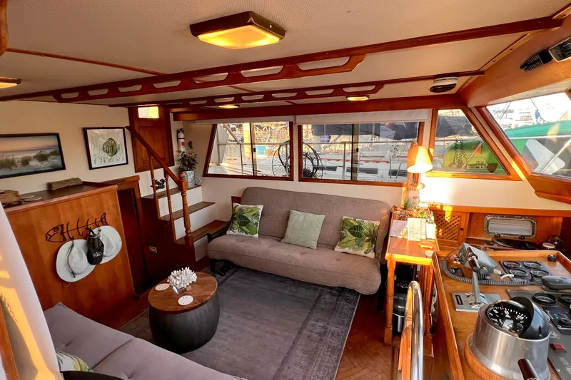 Slide: The Image of Interior of 1985 Heritage East 40 Sundeck Trawler with cozy seating and nautical decor. - 16