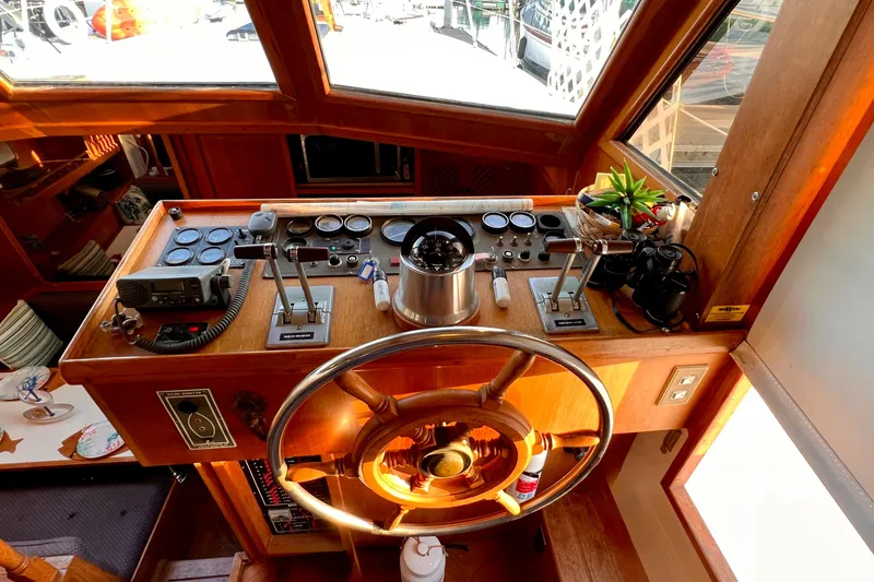 Slide: The Image of Helm of 1985 Heritage East 40 Sundeck Trawler with wooden wheel and navigation instruments. - 17