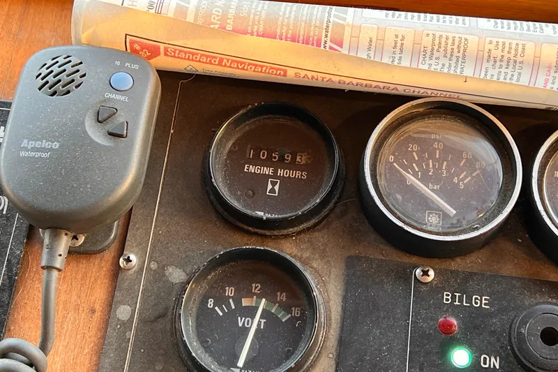 Slide: The Image of Control panel of 1985 Heritage East 40 Sundeck Trawler with gauges and navigation chart. - 19