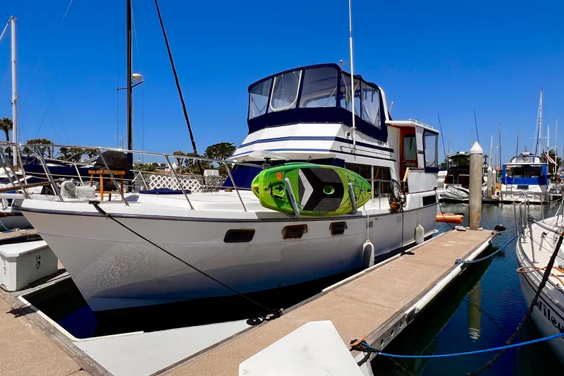 Slide: The Image of 1985 Heritage East 40 Sundeck Trawler docked at marina under clear blue sky. - 2