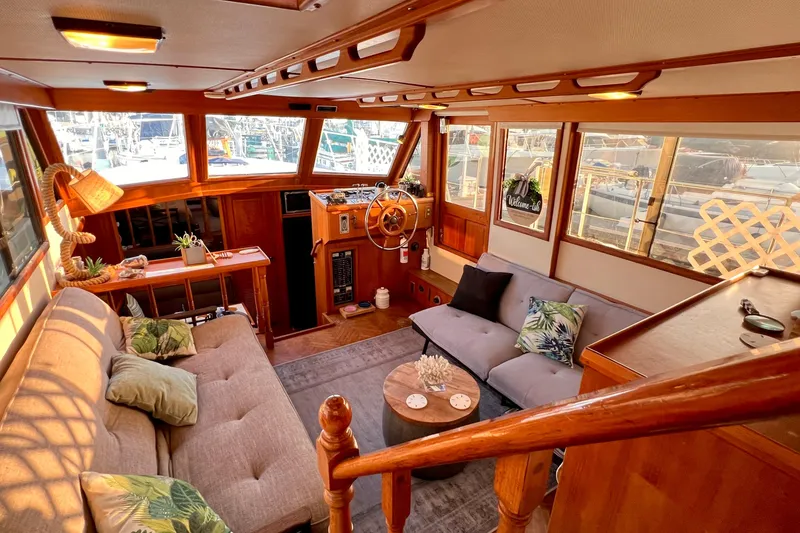 Slide: The Image of Interior of 1985 Heritage East 40 Sundeck Trawler with cozy seating and nautical decor. - 20